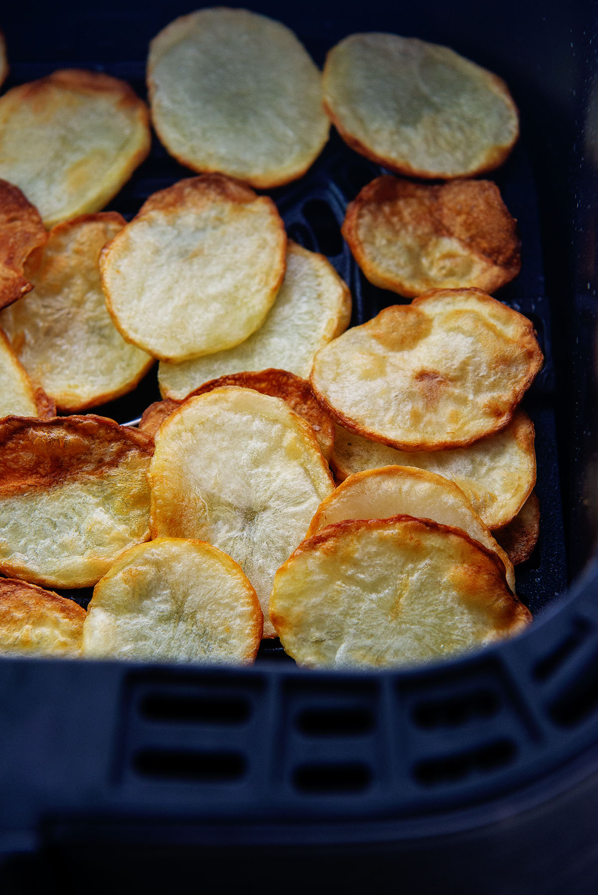 crispy chips in air fryer basket.