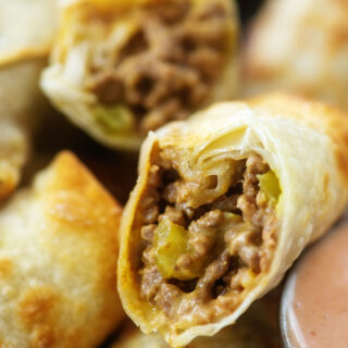 Cheeseburger egg rolls cut open to show the filling.