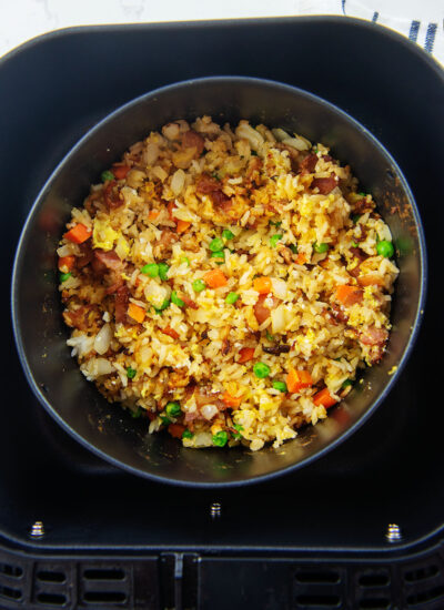 Overhead view of fried rice in a baking dish in an air fryer basket