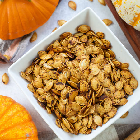 Cooked pumpkin seeds in a square bowl