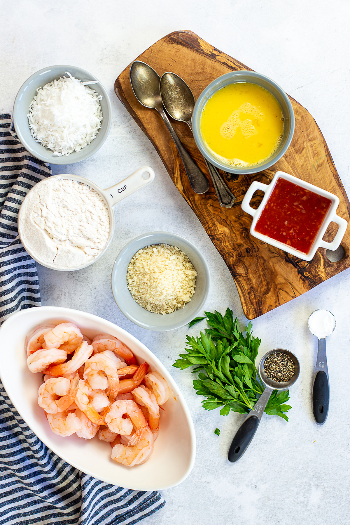 Coconut shrimp ingredients spread out on a countertop.