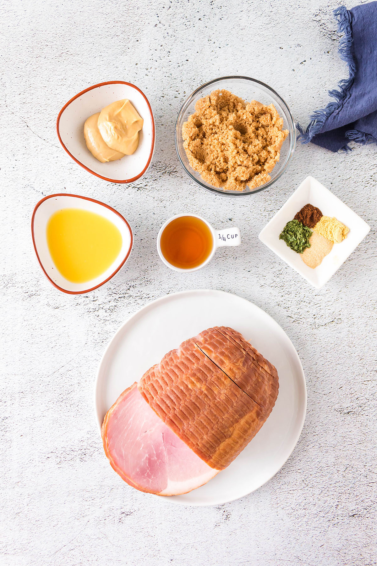 Homemade glazed ham ingredients spread out on a countertop.