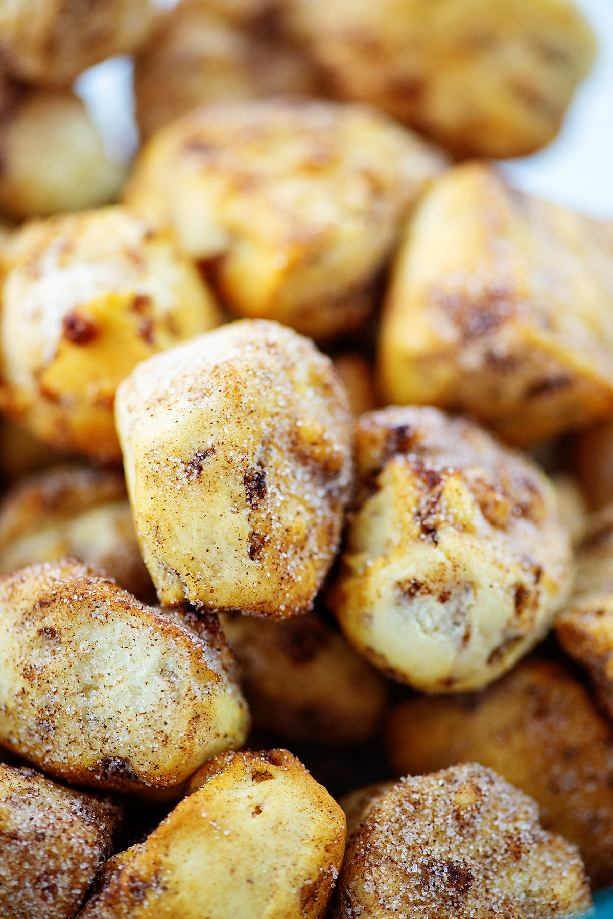 Close up of cinnamon roll bites with a coating of cinnamon and sugar on top.