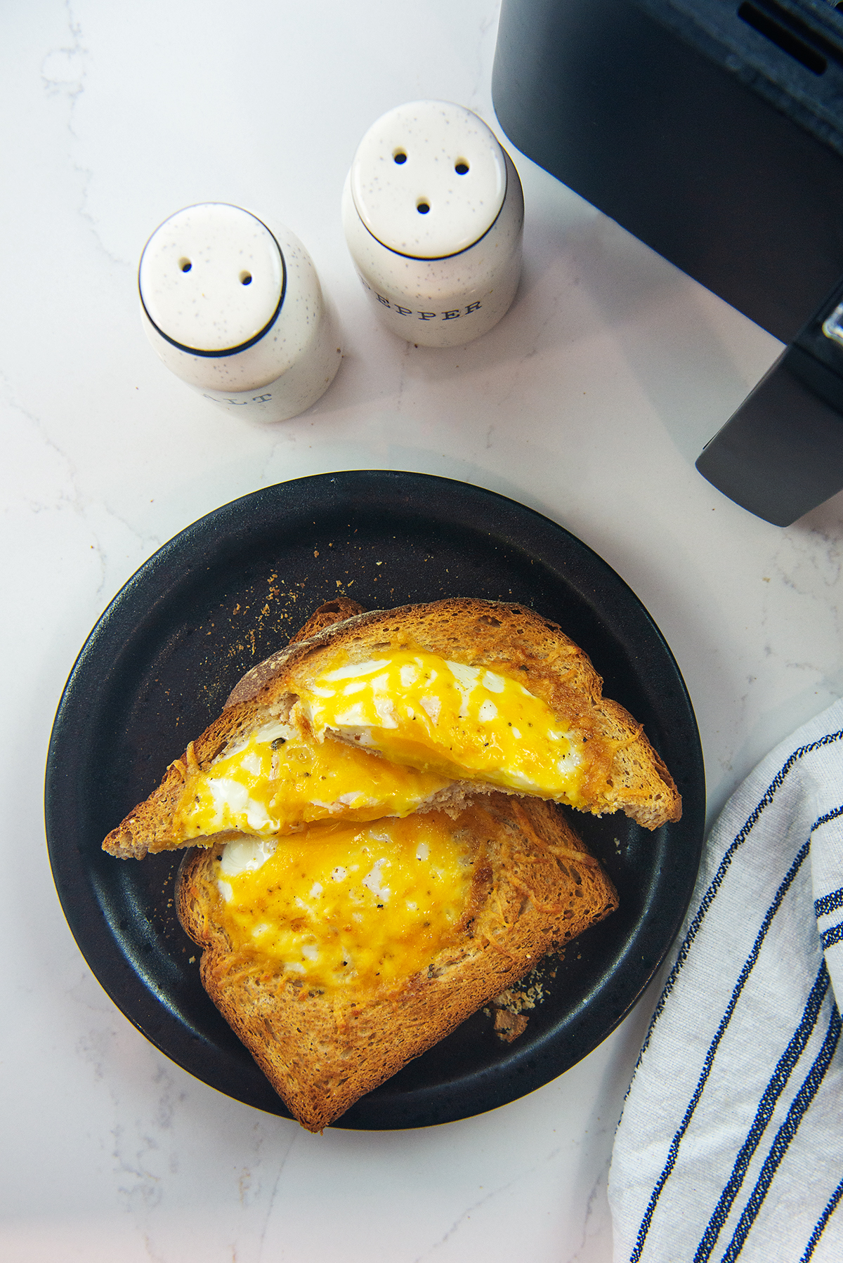 cheesy egg toast on plate.