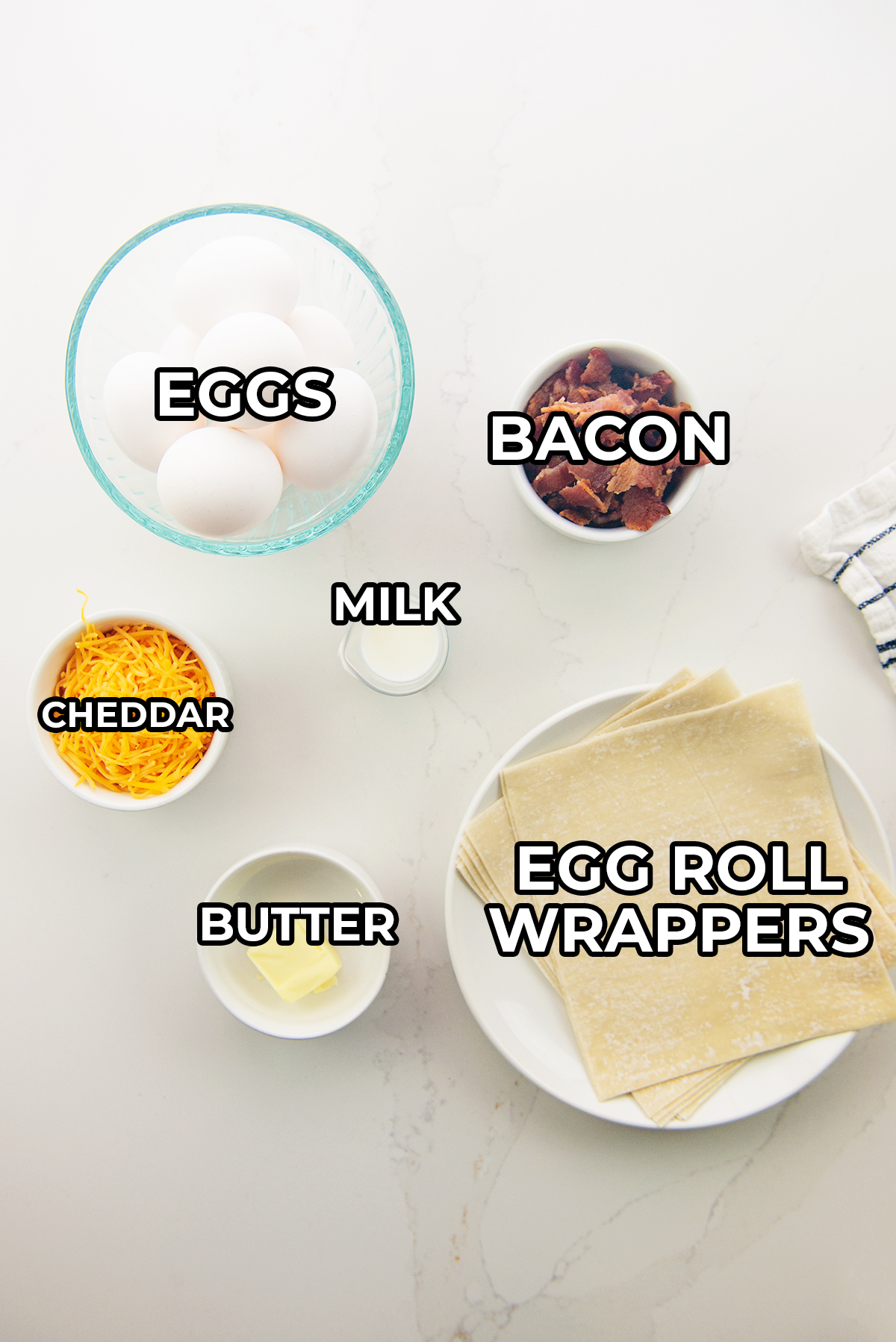 breakfast egg roll ingredients spread out on a countertop.
