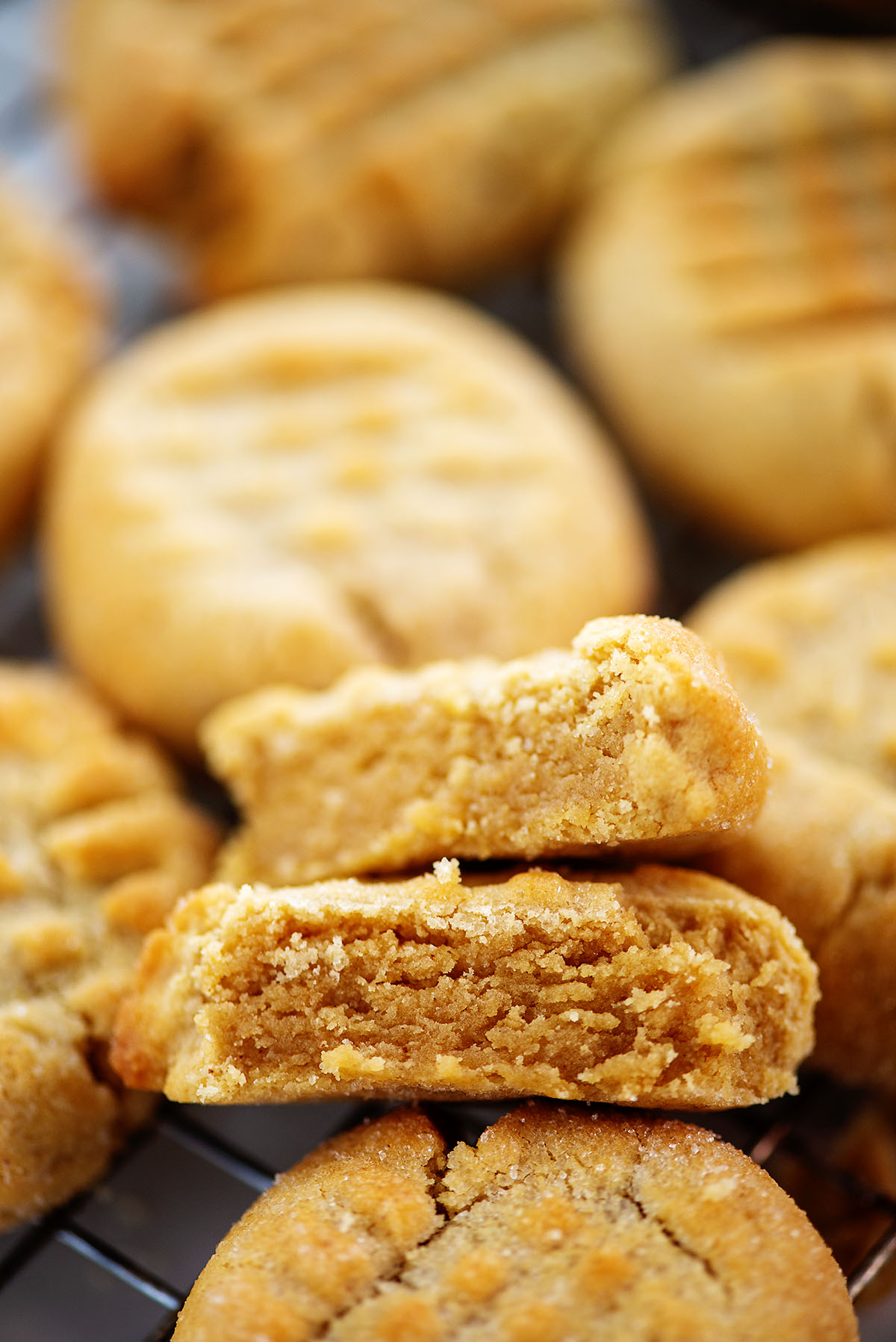 Close up of stacked peanut butter cookies on a cooling rack.