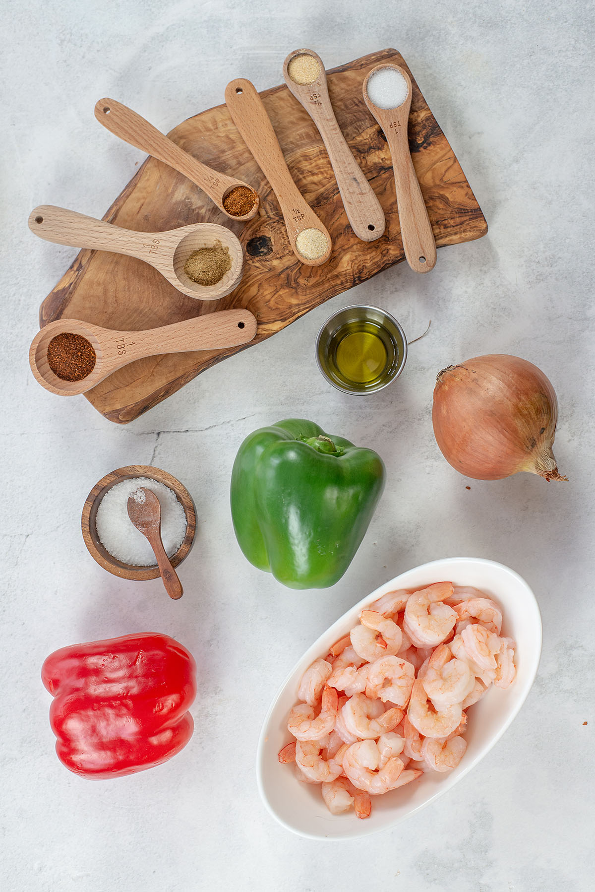 Shrimp fajita ingredients spread out on a countertop.