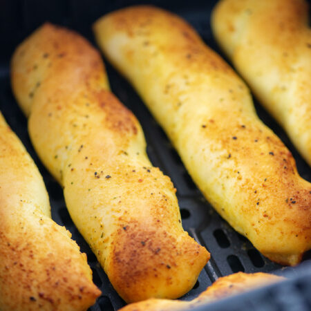 Close up of breadsticks in an air fryer.