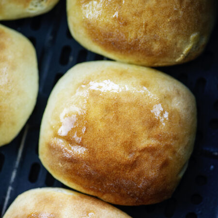 Close up of a dinner roll in an air fryer.