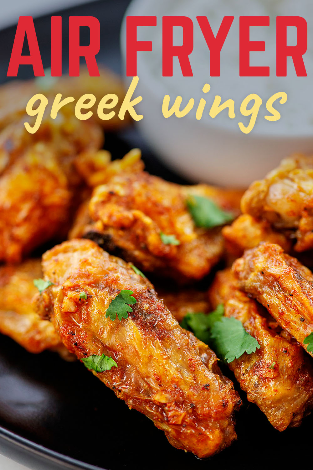 Close up of a stack of greek chicken wings.