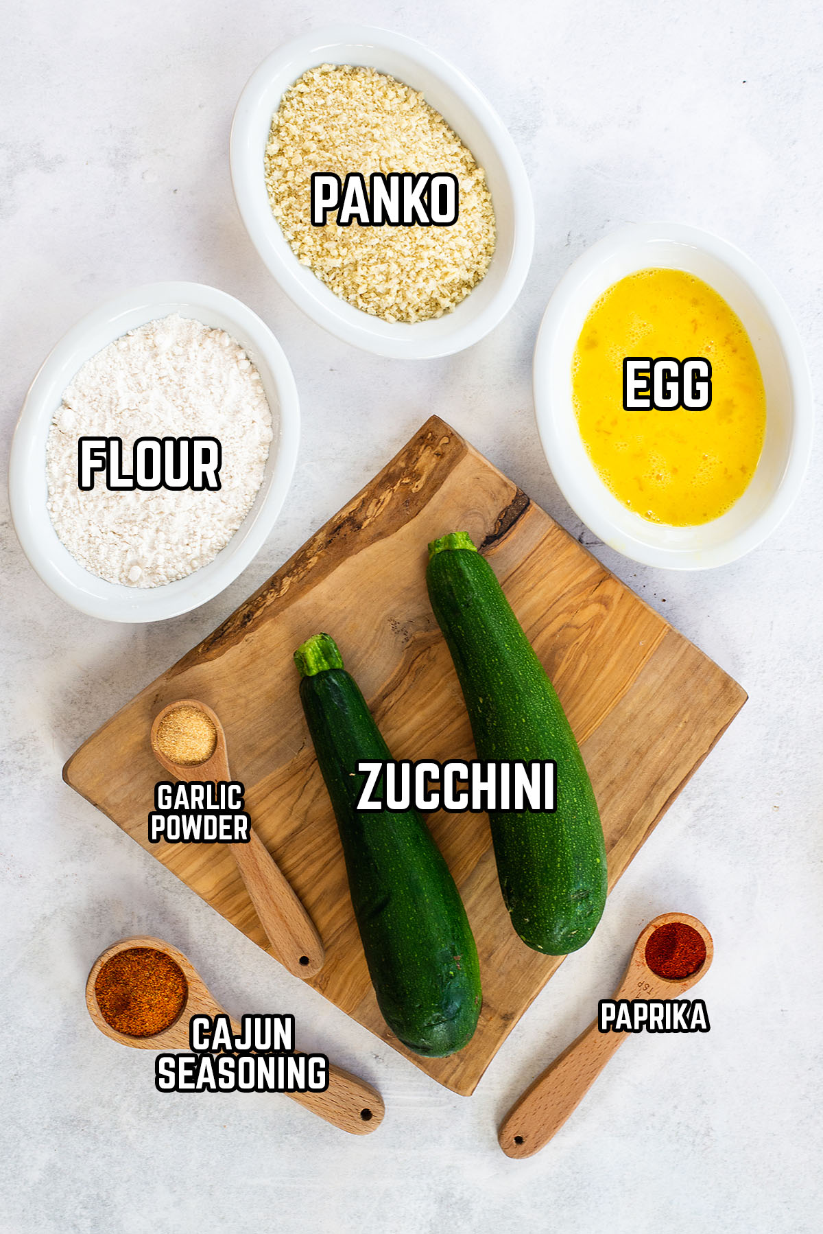 Zucchini chips ingredients spread out on a countertop.