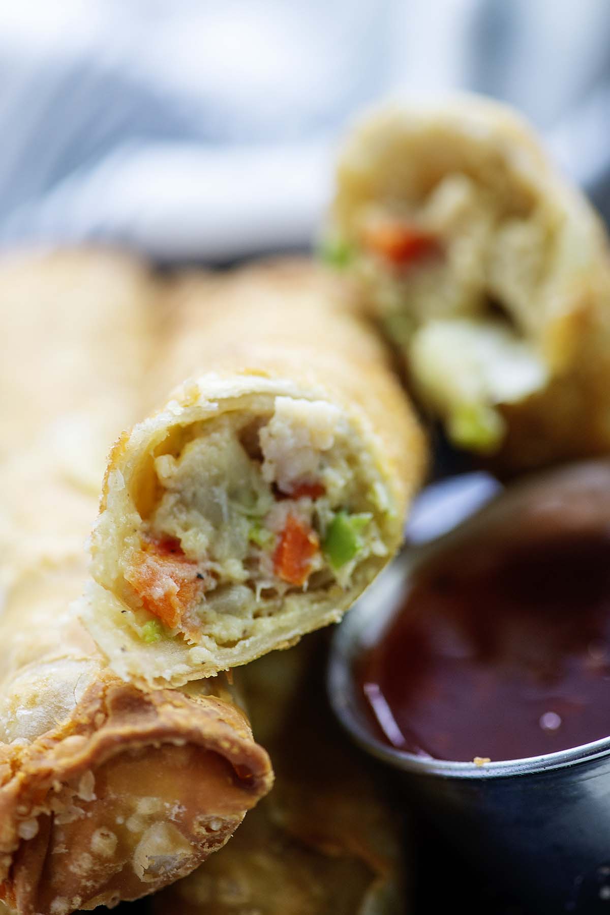 Close up of an egg roll cut in half.