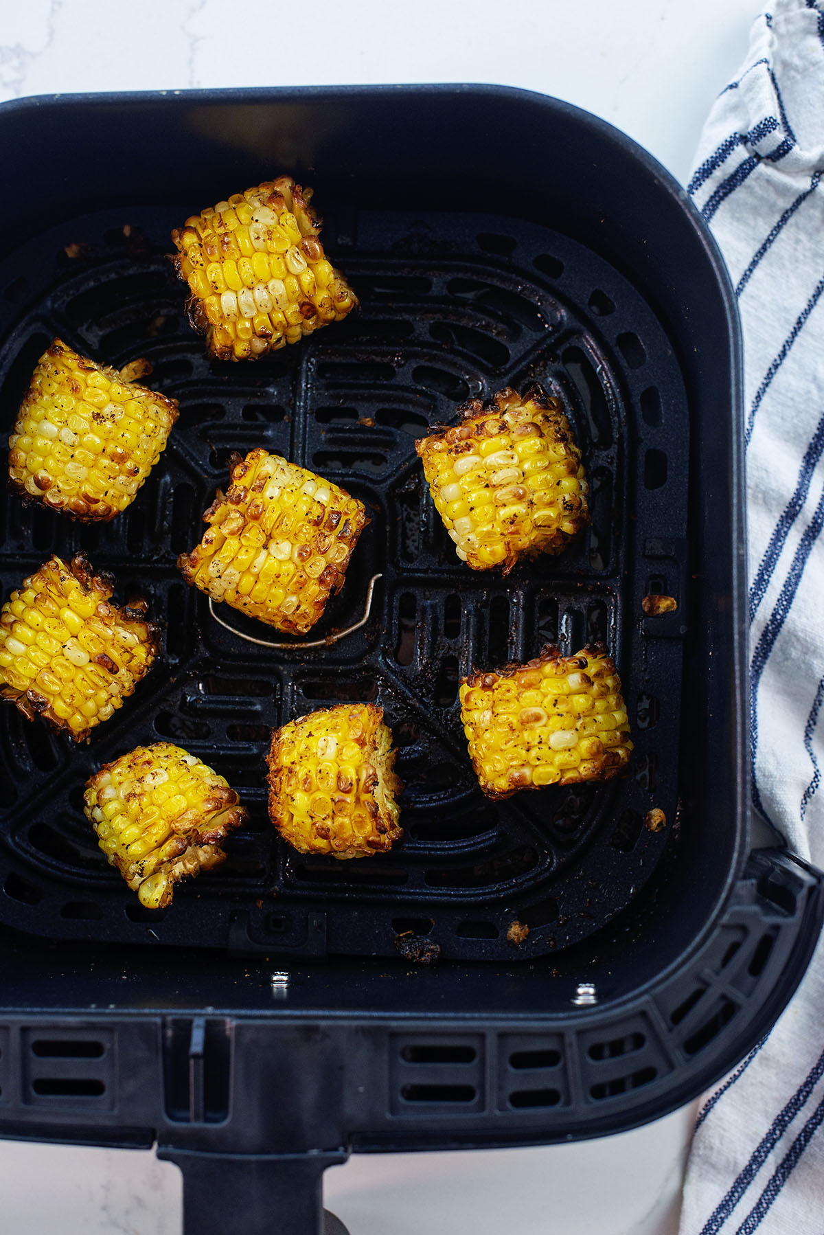cajun fried corn in air fryer basket.