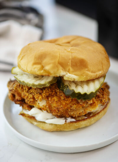 Air fried chicken sandwich on a small white plate.