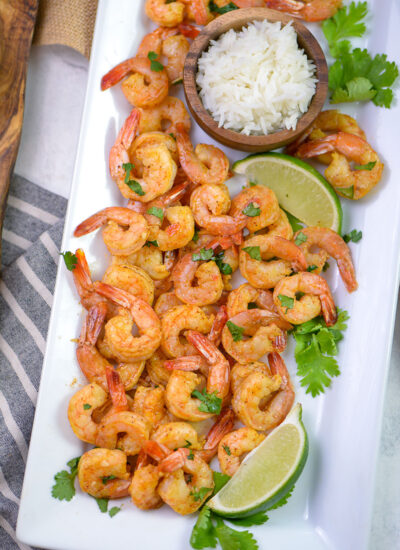 A serving plate full of chili lime shrimp.