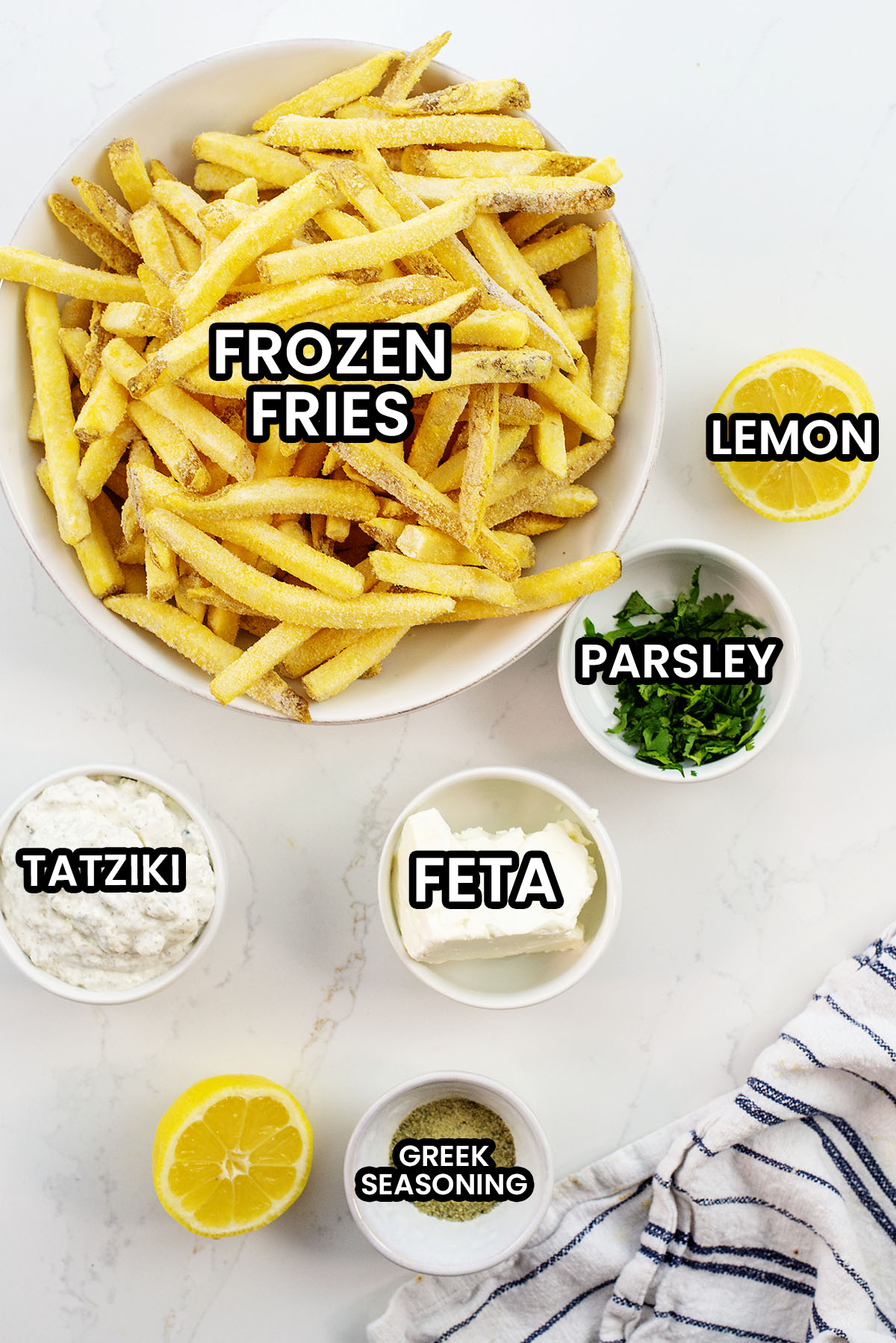Greek fries ingredients on a counter top.