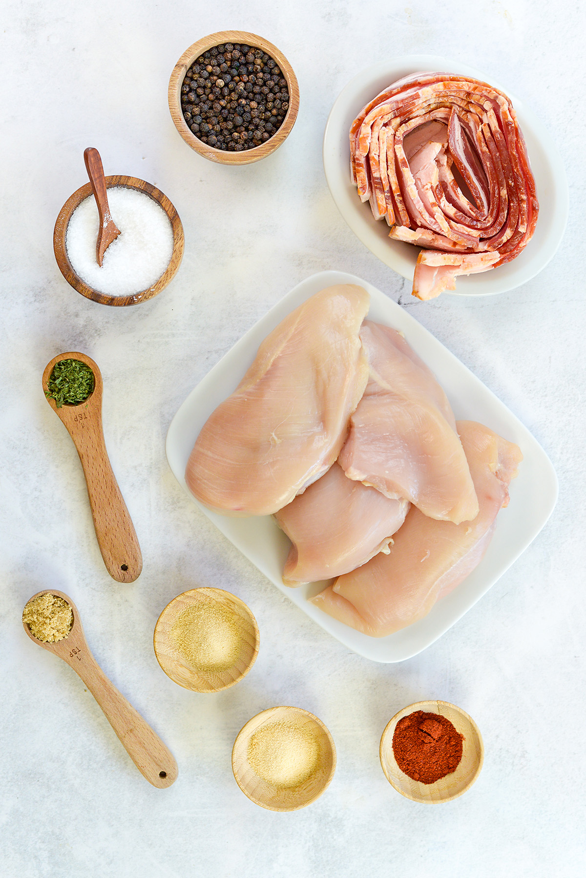 BAcon wrapped chicken ingredients spread out on a countertop.