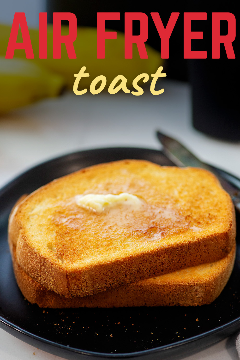 Close up of buttered toast on a black plate.