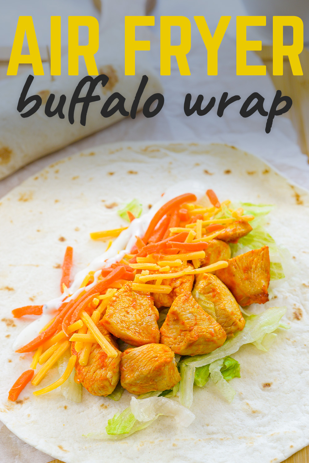 These easy Air Fryer Buffalo Chicken Wraps are an easy way to get lunch on the table! We toss bits of chicken in buffalo sauce, cook them in the air fryer, and then pile it on a tortilla with cheese, lettuce, and dressing to make a simple, flavorful wrap!