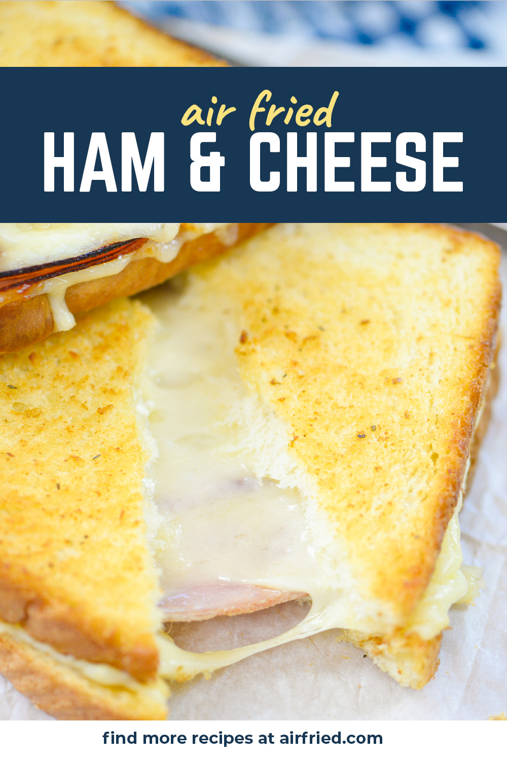Close up of a cut ham and cheese sandwich.