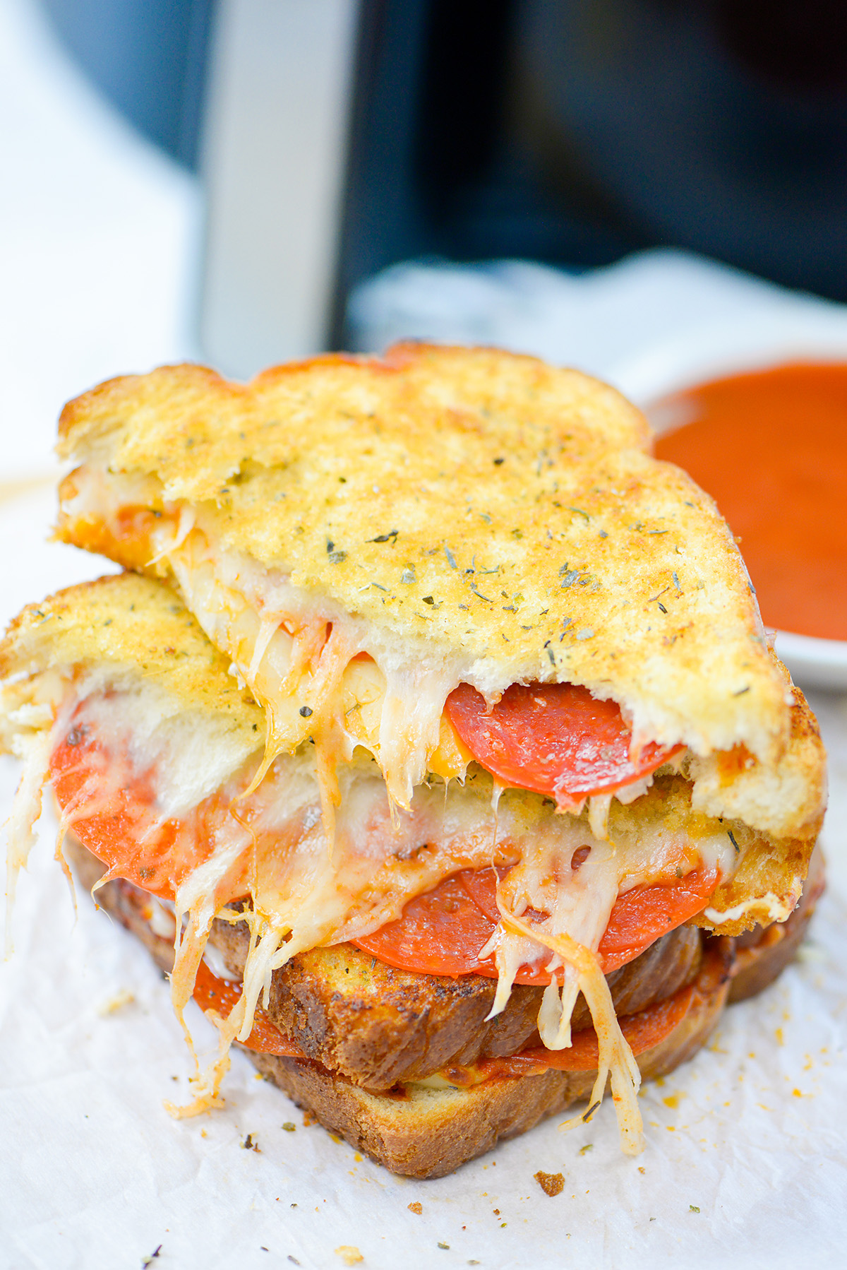 Pizza grilled cheese cut in half.