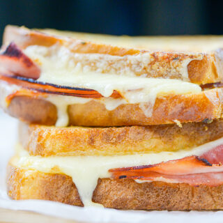 Close up of two ham and cheese sandwiches.