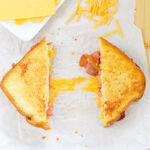 A pulled apart bacon grilled cheese.