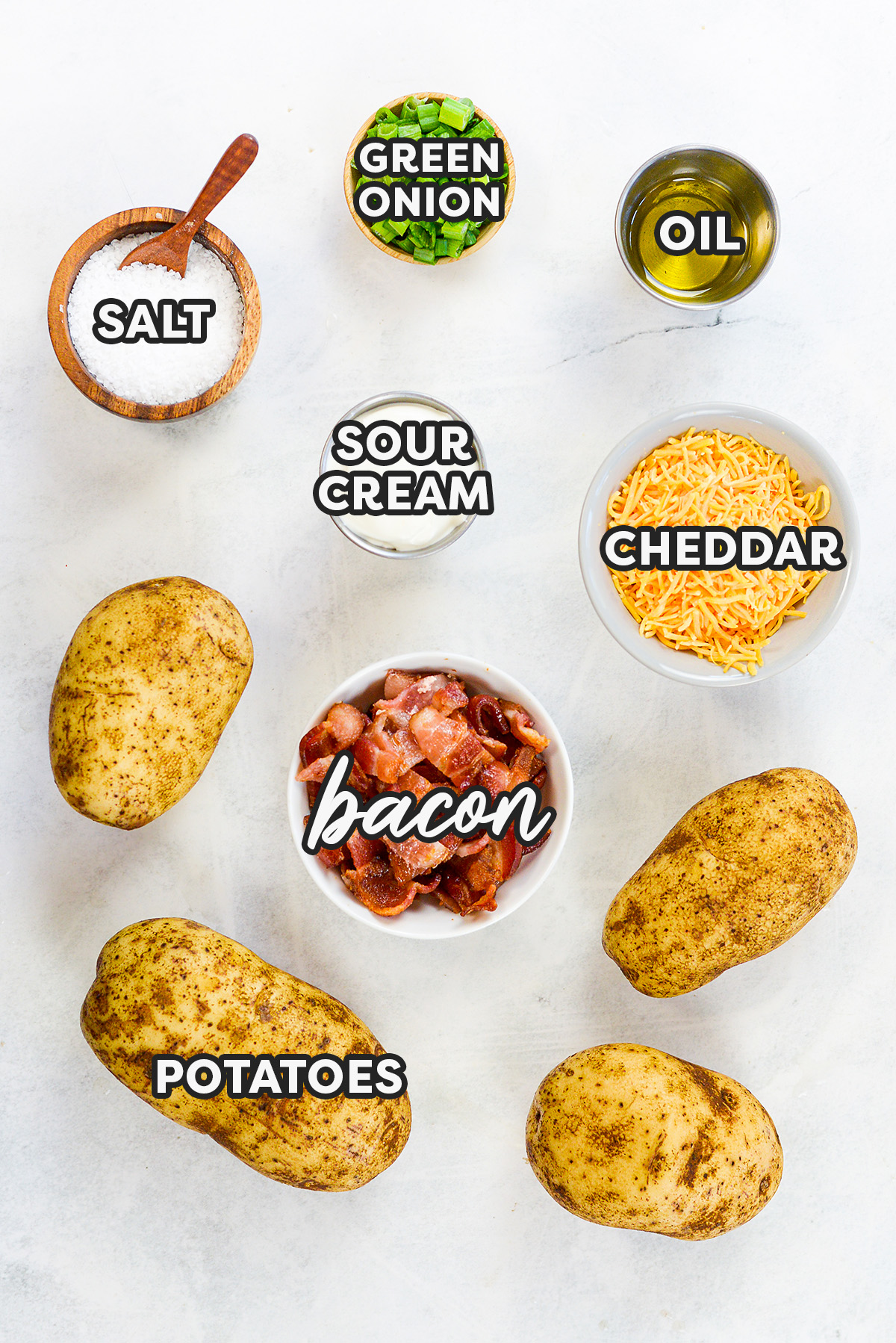 Loaded potato skin ingredients spread out on a countertop.
