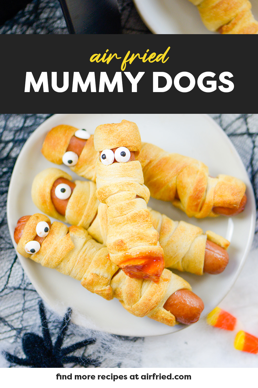Four mummy dogs on a small white plate.