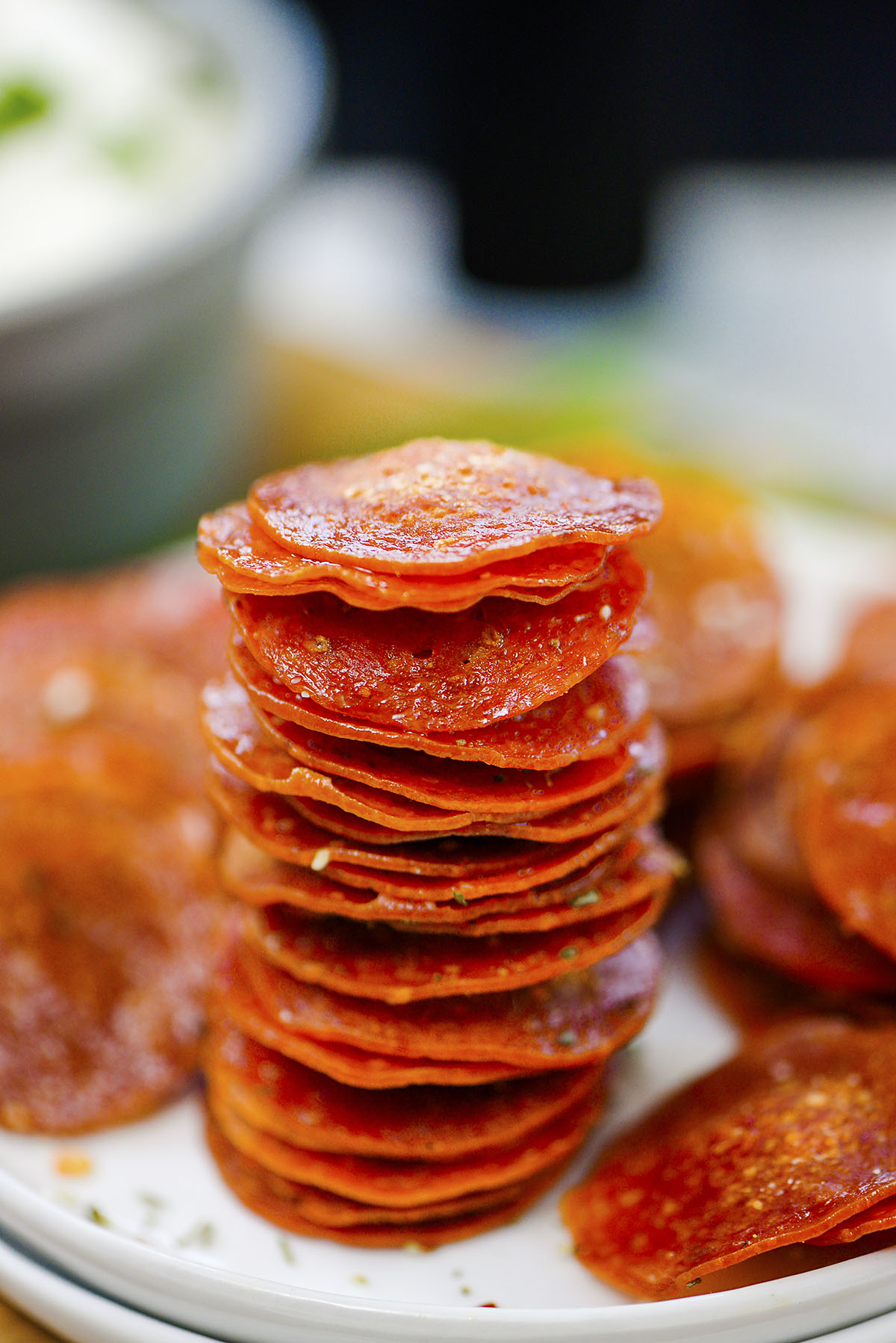 Pepperoni chips stacked up in a column.