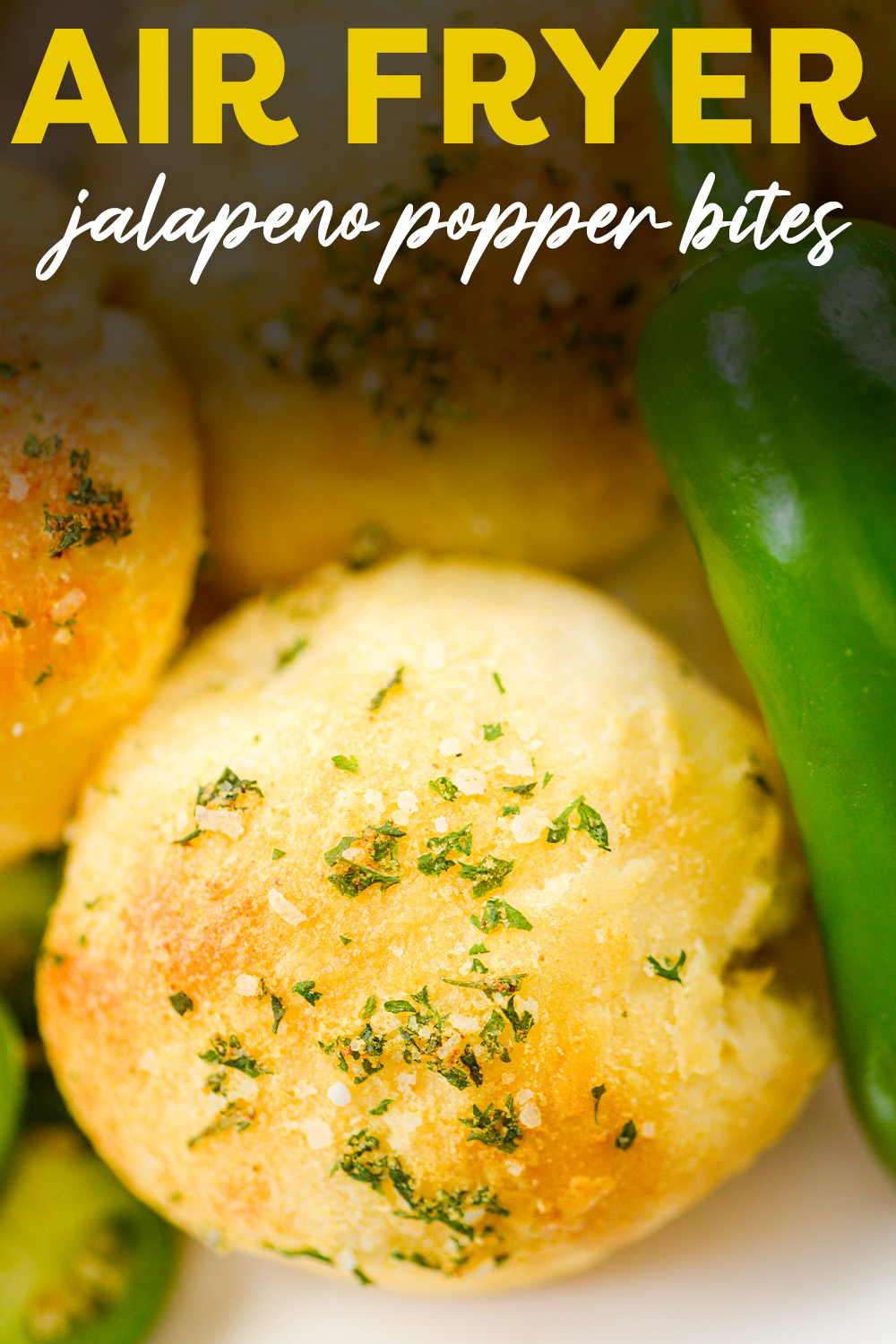 Close up of a jalapeno popper biscuit bite next to a pepper.