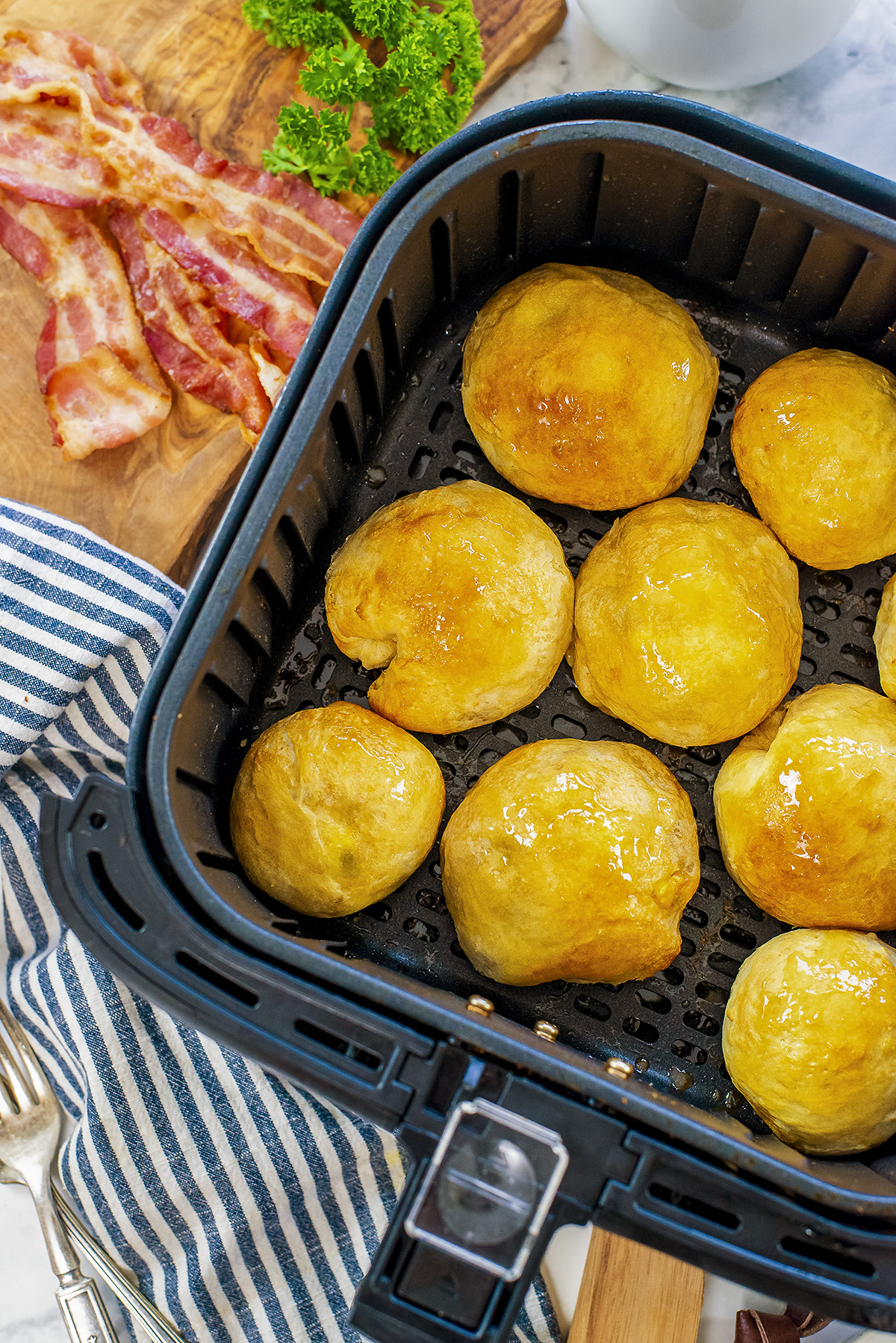 Close up of several breakfast bites in an airf fryer basket.
