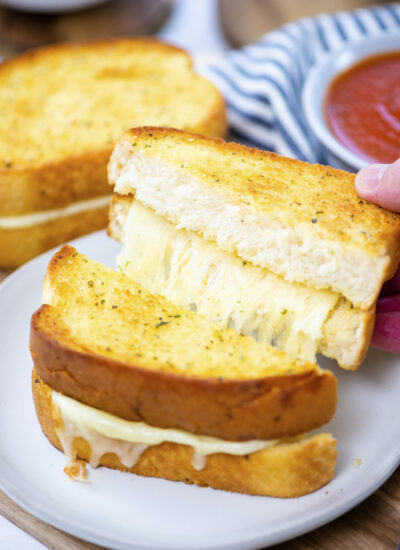 Close up of garlic grilled cheese sandwich cut in half.