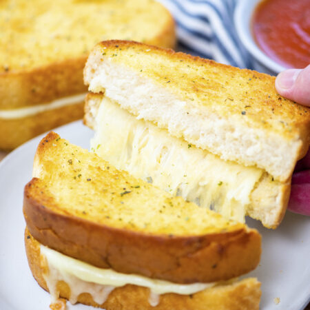 Close up of garlic grilled cheese sandwich cut in half.