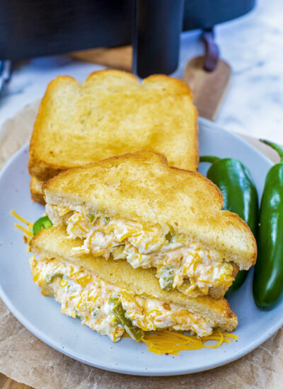 Two jalapeno popper grilled cheese sandwiches on a plate.