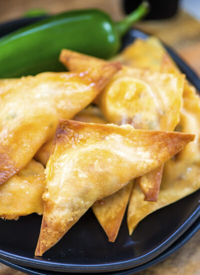 Close up of a wonton with a jalapeno pepper.