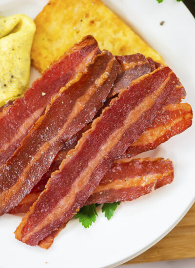 Cooked turkey bacon on a plate.