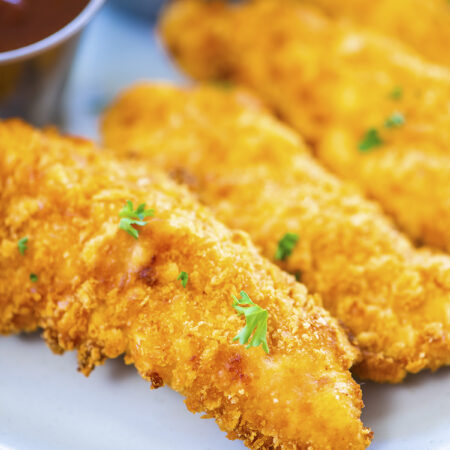 Close up of a breaded chicken tender.
