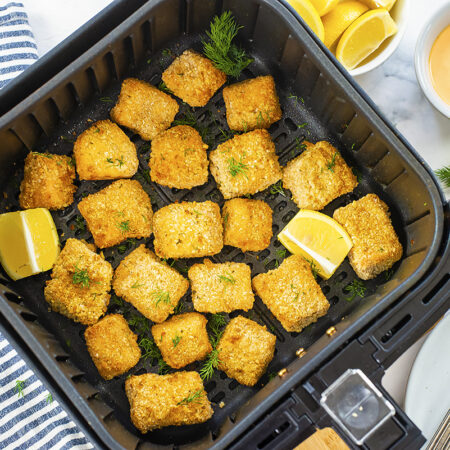 Salmon nuggets in an air fryer basket.