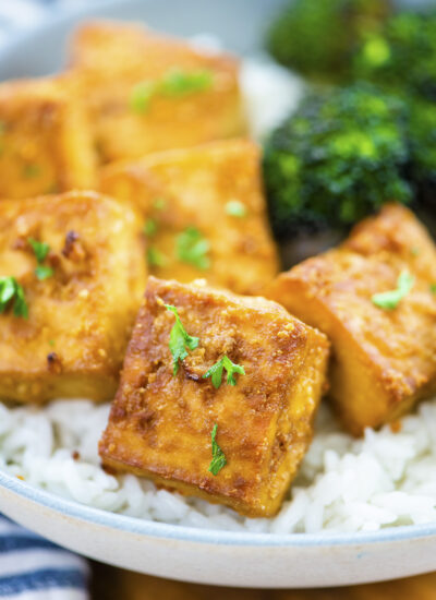 Close up of crispy tofu on rice.