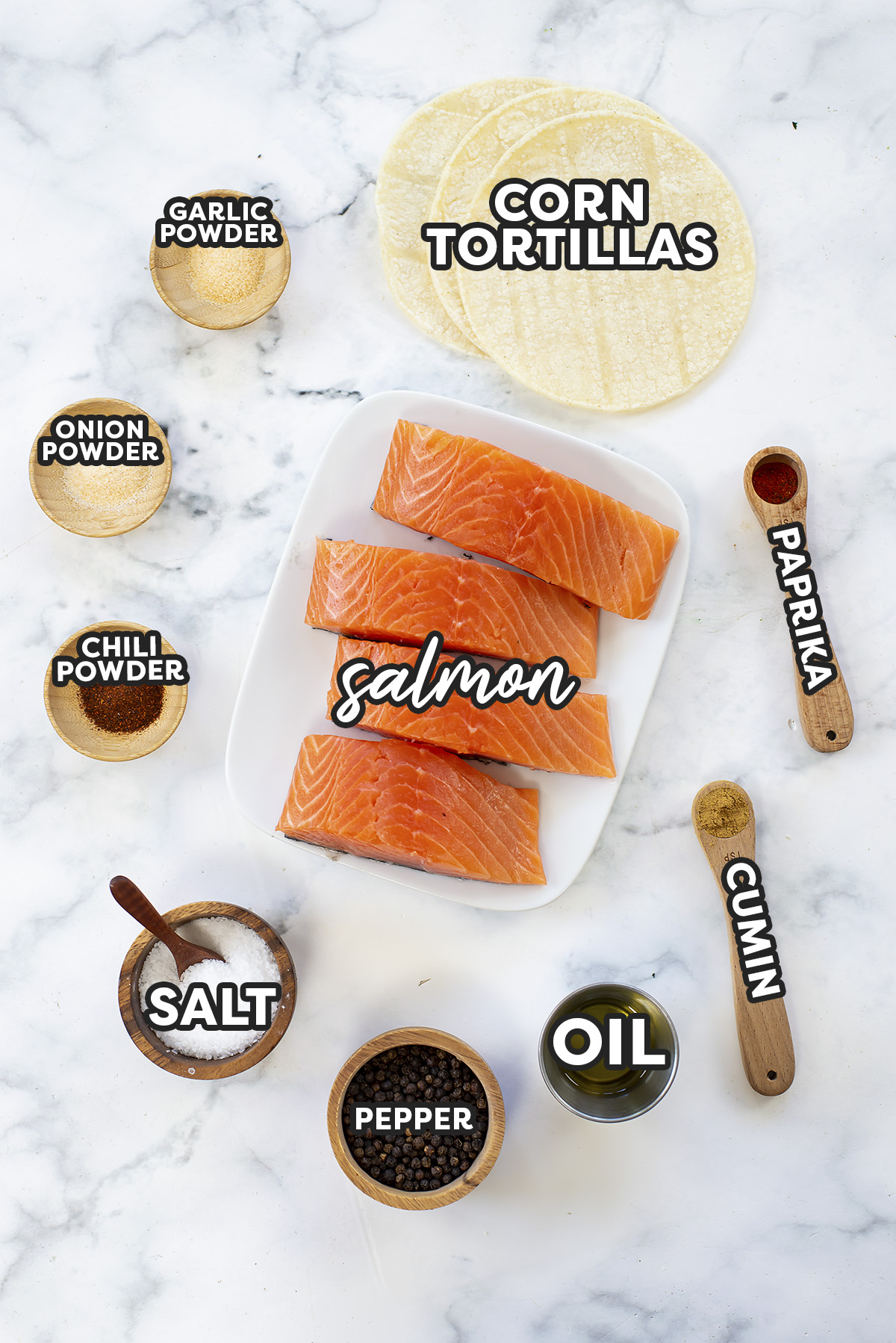 Ingredients for salmon tacos spread out on a countertop.