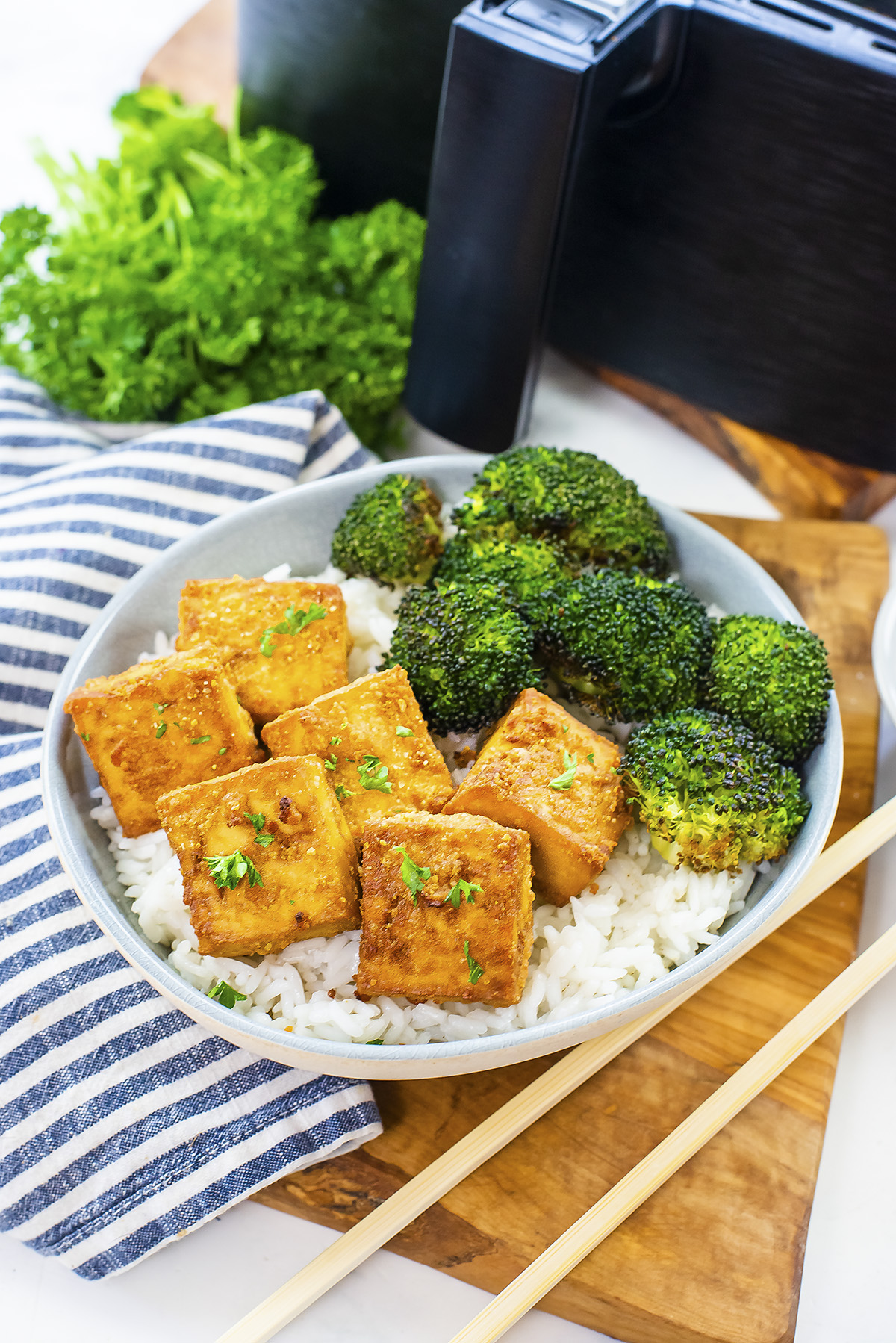 Tofu and broccoli on top of rice.