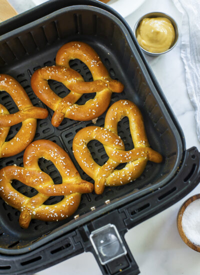 Air fryer basket full of pretzels on a countertop.