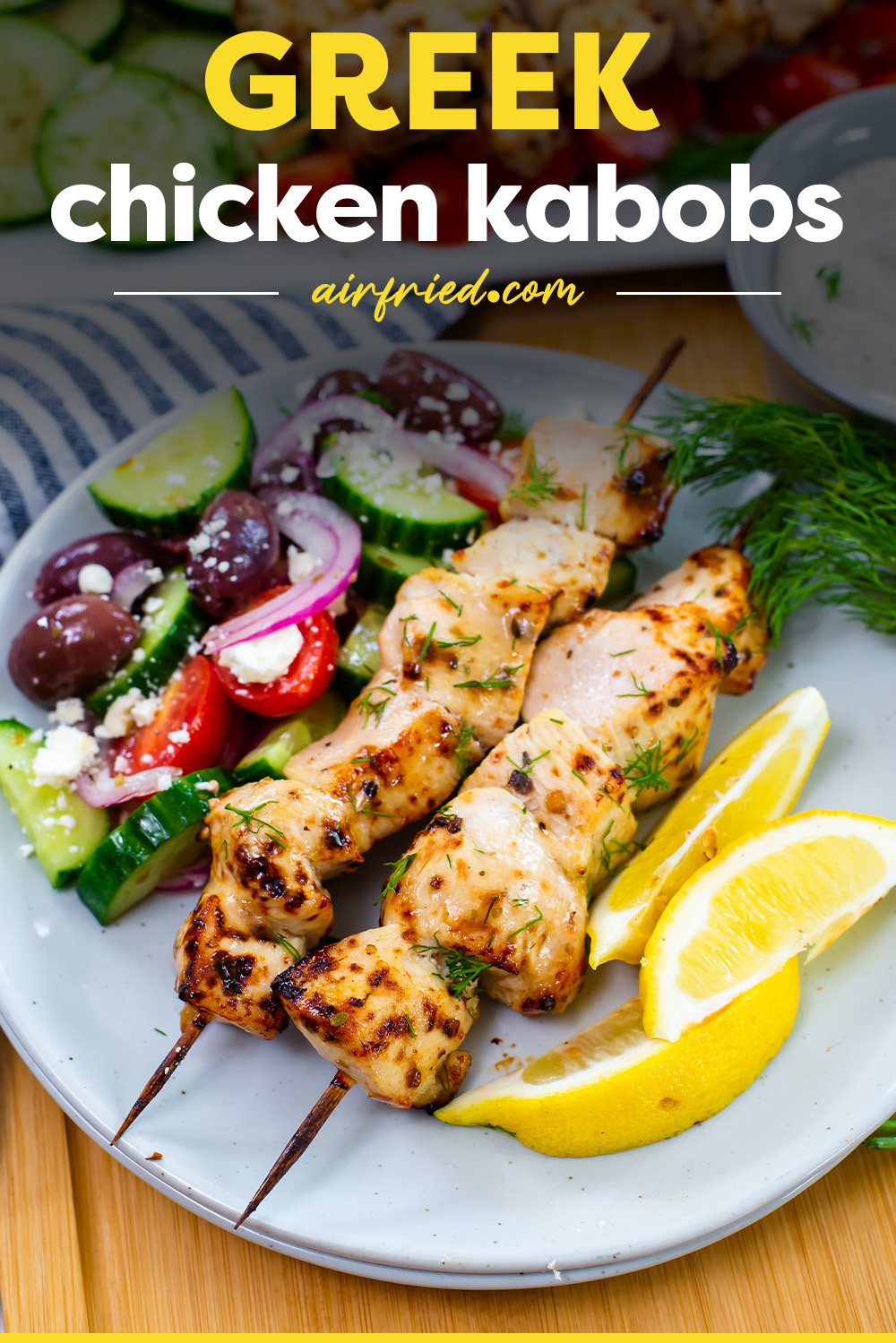 Two Greek chicken kabobs on a plate.
