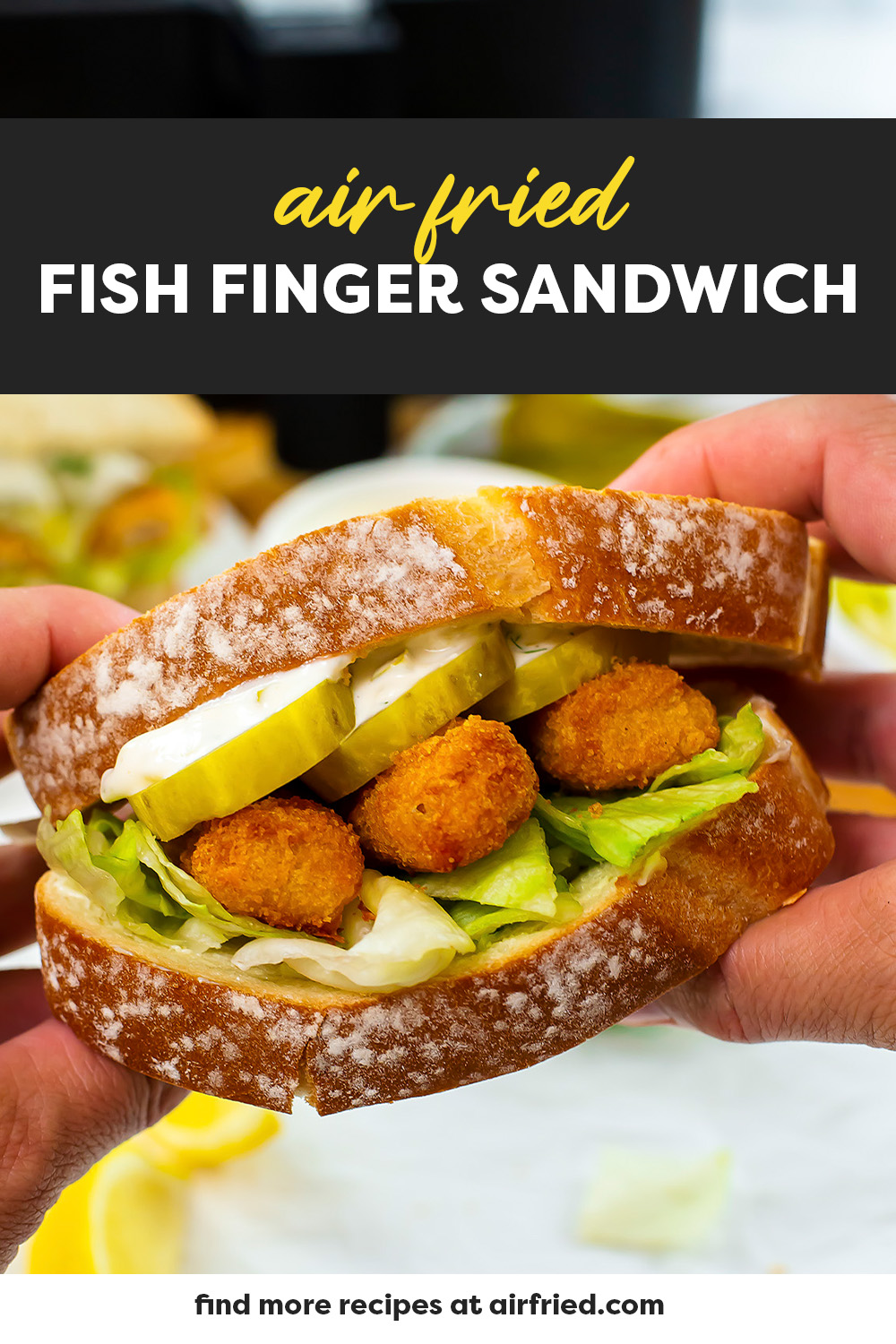 Close up of a person holding up a fish finger sandwich.