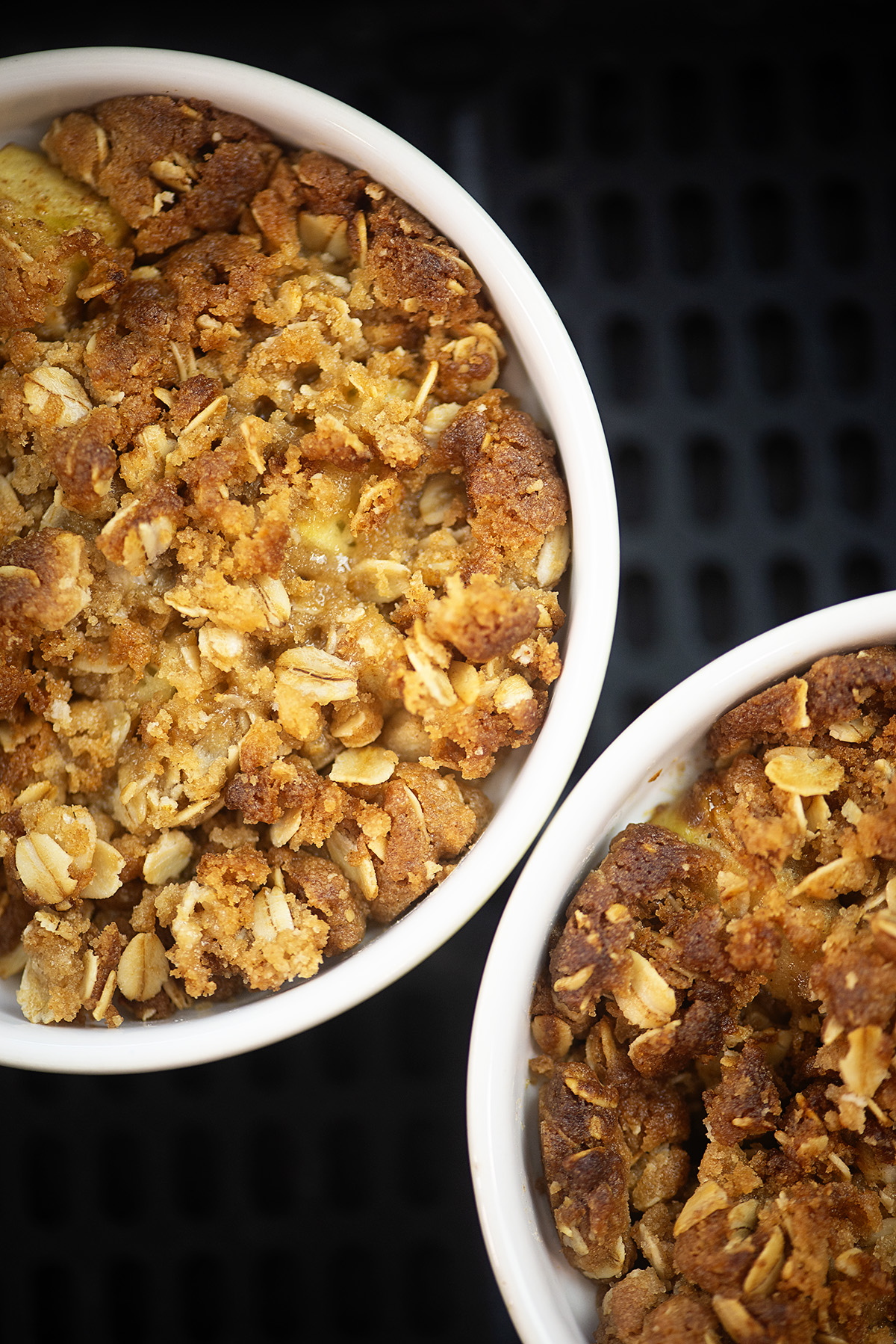 Close up of cooked apple crisp in an air fryer.