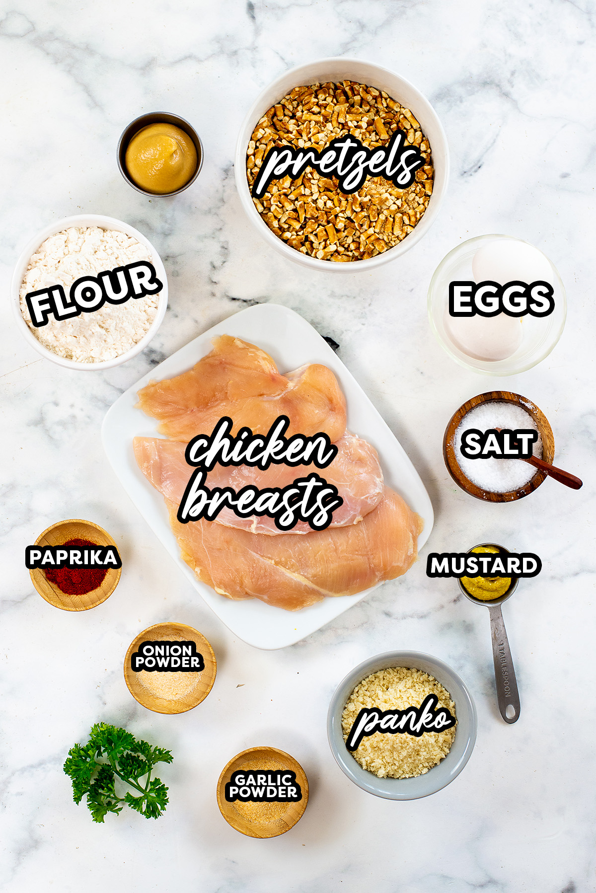 Pretzel crusted chicken ingredients on a white countertop.