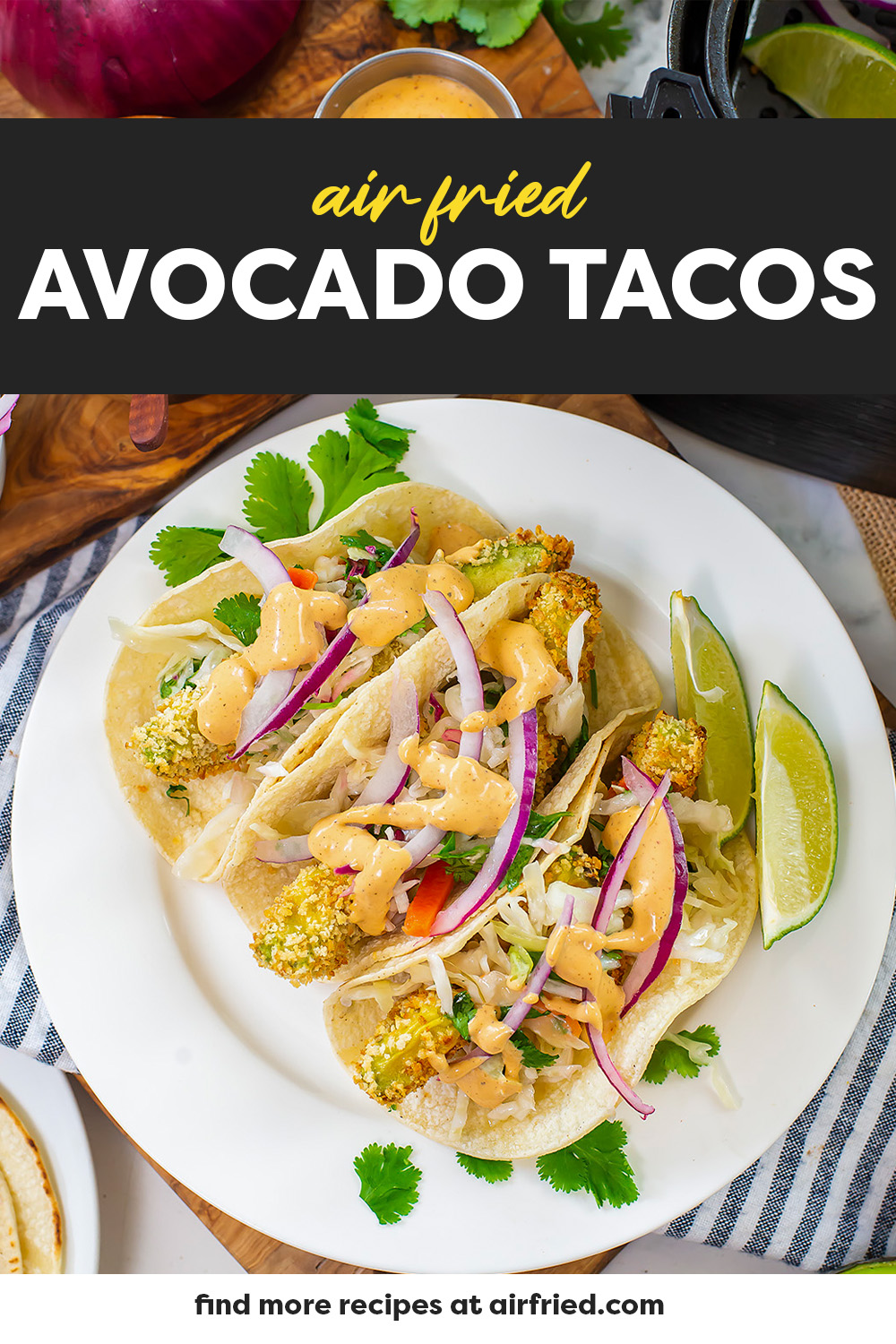 A white plate with three avocado tacos on it.