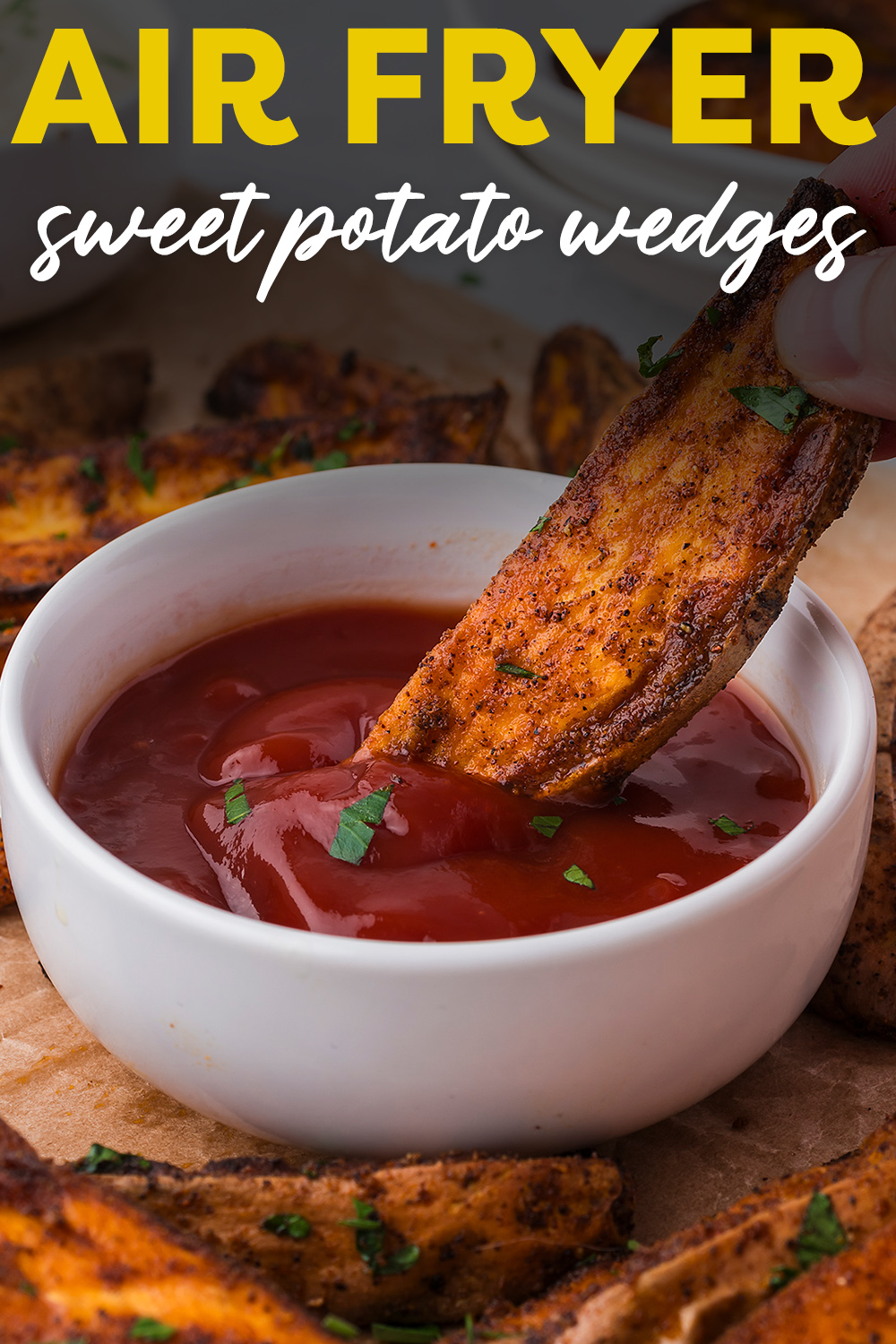 A sweet potato wedge dipped in ketchup.