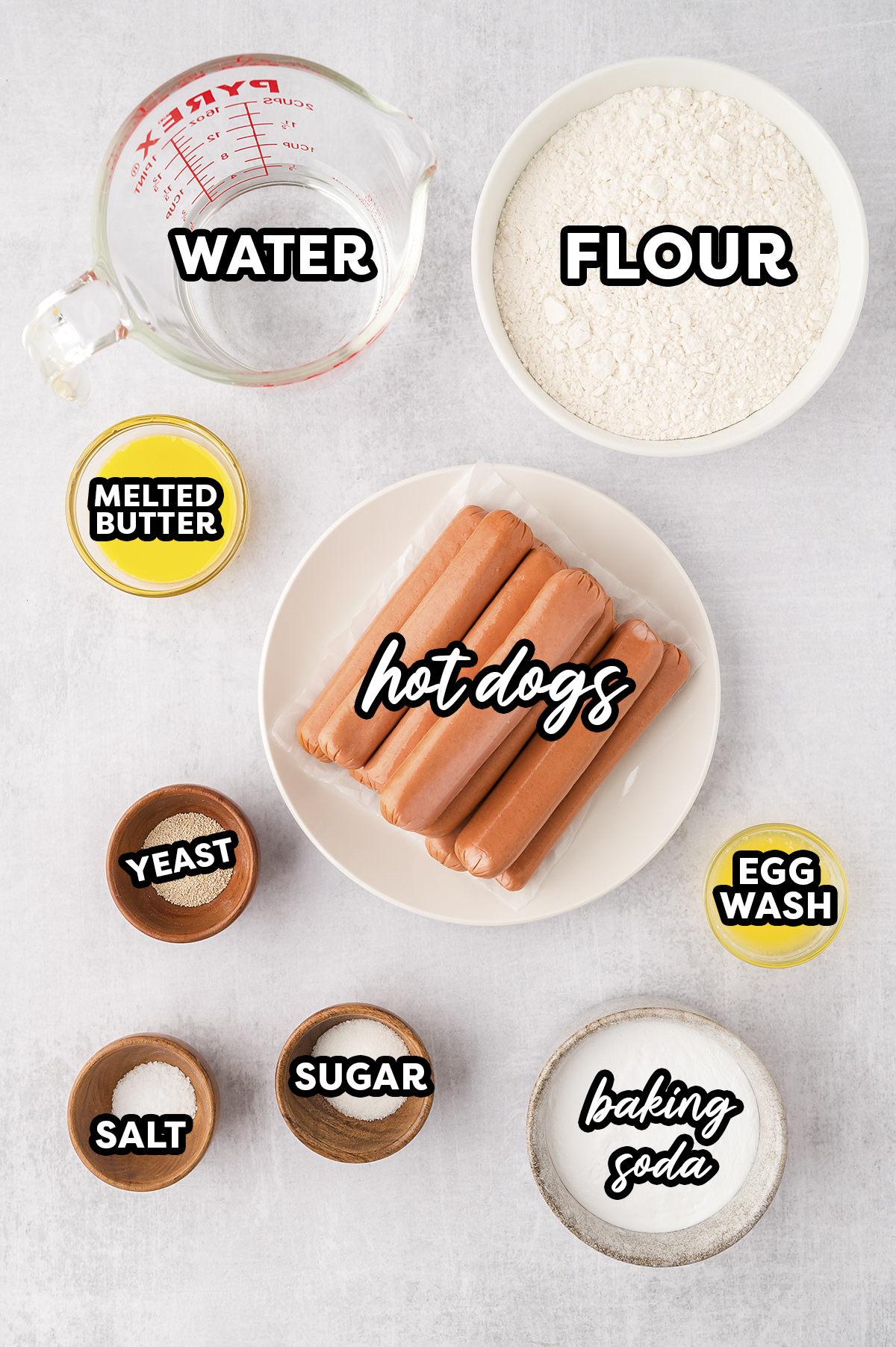 Ingredients for pretzel dogs spread out on a countertop.